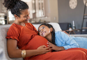 Pregnant woman with her daughter