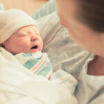 Small image of newborn being comforted